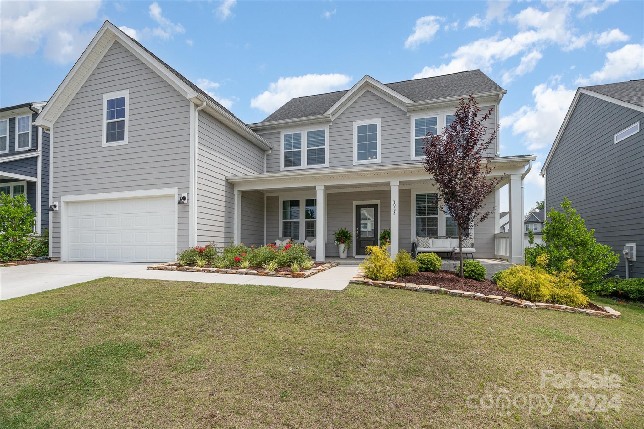 3063 Patchwork Court Fort Mill, SC 29708 - Photo 1 of 28 a front view of a house with a yard and outdoor seating