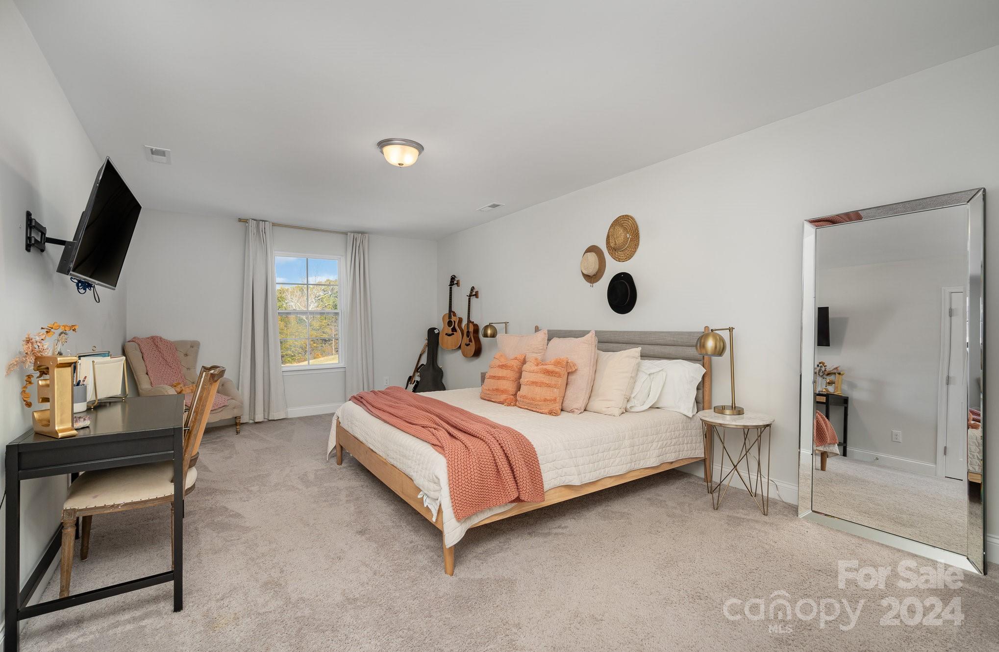 3063 Patchwork Court Fort Mill, SC 29708 - Photo 22 of 28 a bedroom with a bed and flat screen tv