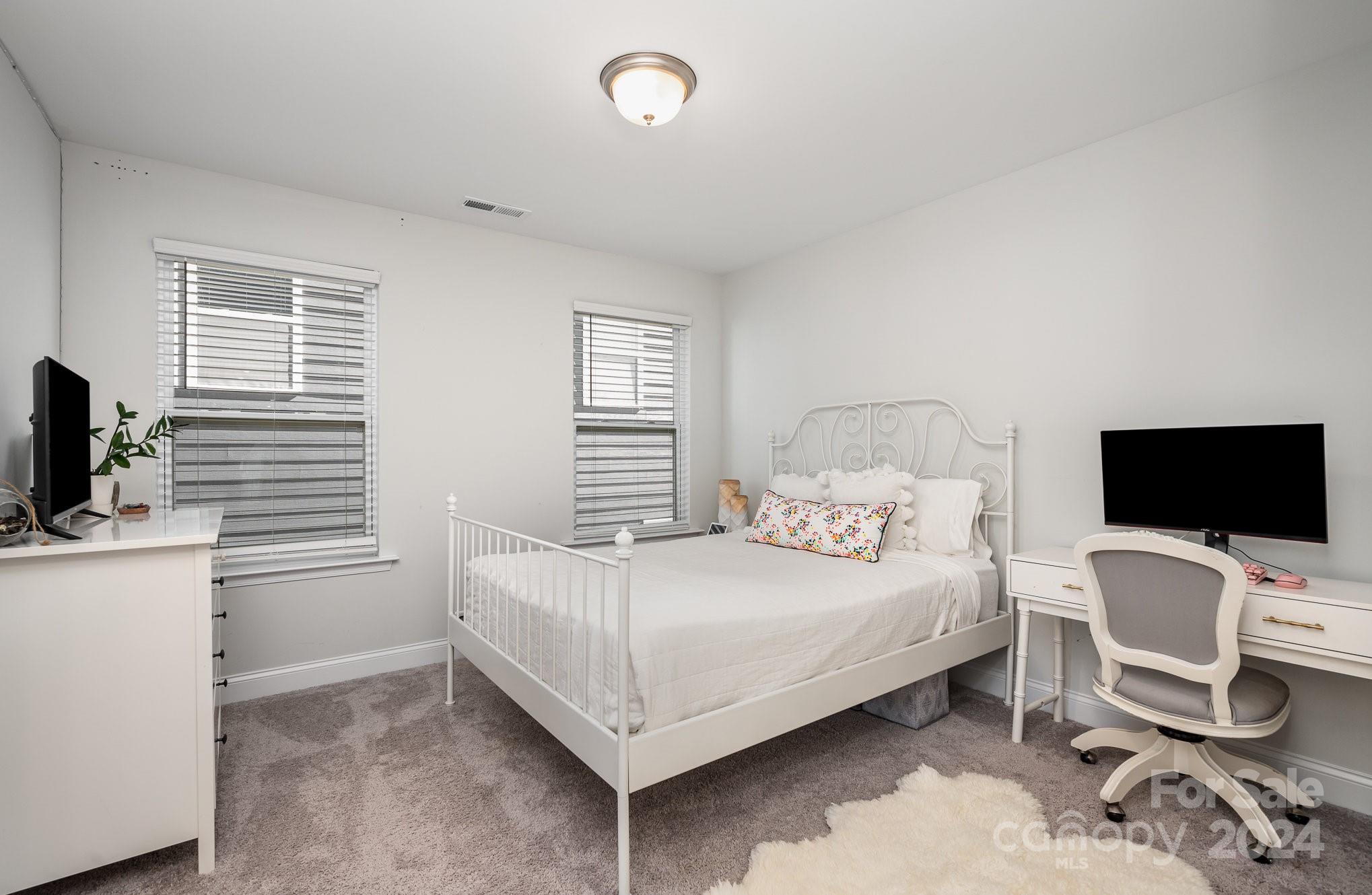 3063 Patchwork Court Fort Mill, SC 29708 - Photo 24 of 28 a bedroom with a bed and a flat screen tv