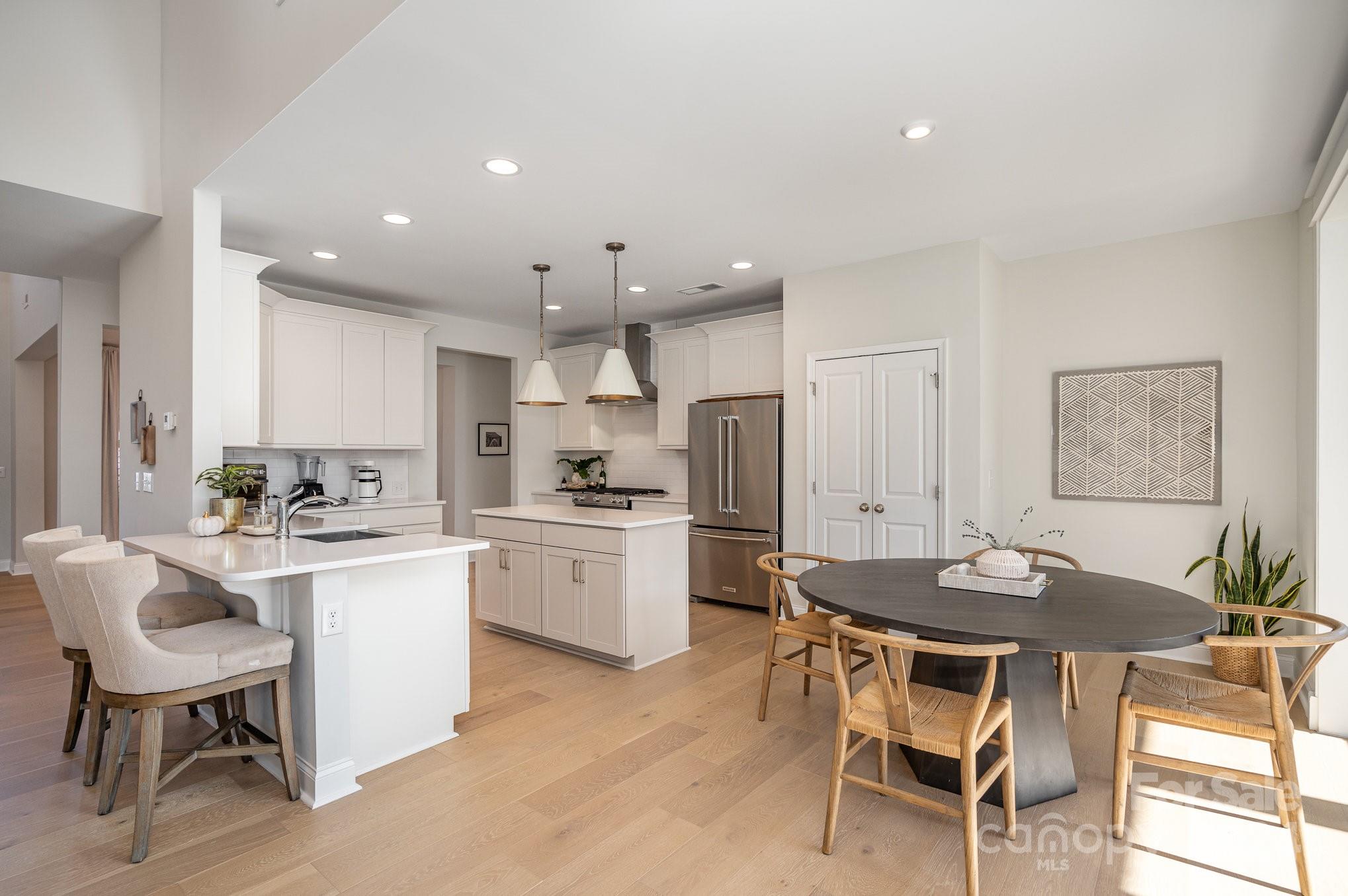 3063 Patchwork Court Fort Mill, SC 29708 - Photo 8 of 28 a kitchen with a dining table chairs and refrigerator