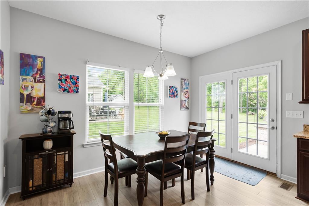5018 Firwood Drive Canonsburg, PA 15317 - Photo 15 of 50 a view of a dining room with furniture large windows and wooden floor