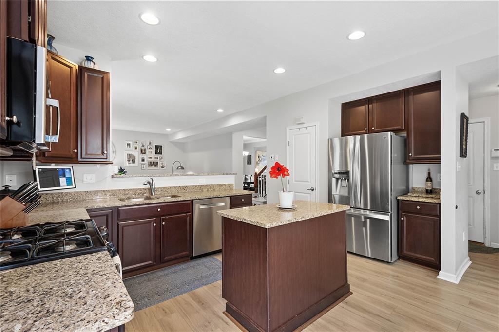 5018 Firwood Drive Canonsburg, PA 15317 - Photo 16 of 50 a kitchen with stainless steel appliances granite countertop a sink stove and refrigerator