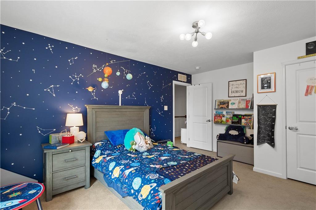 5018 Firwood Drive Canonsburg, PA 15317 - Photo 25 of 50 a bedroom with a bed and a chandelier