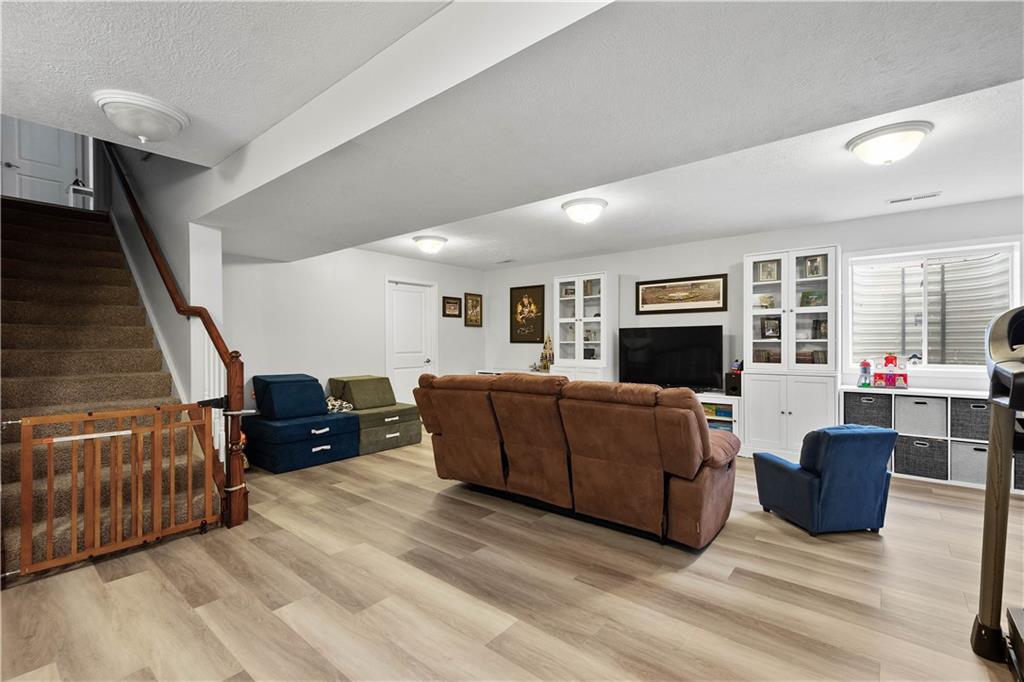 5018 Firwood Drive Canonsburg, PA 15317 - Photo 32 of 50 a living room with furniture and a flat screen tv