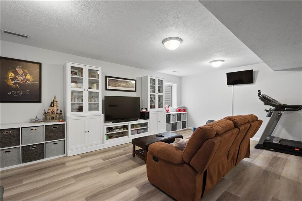 5018 Firwood Drive Canonsburg, PA 15317 - Photo 33 of 50 a living room with furniture and a flat screen tv