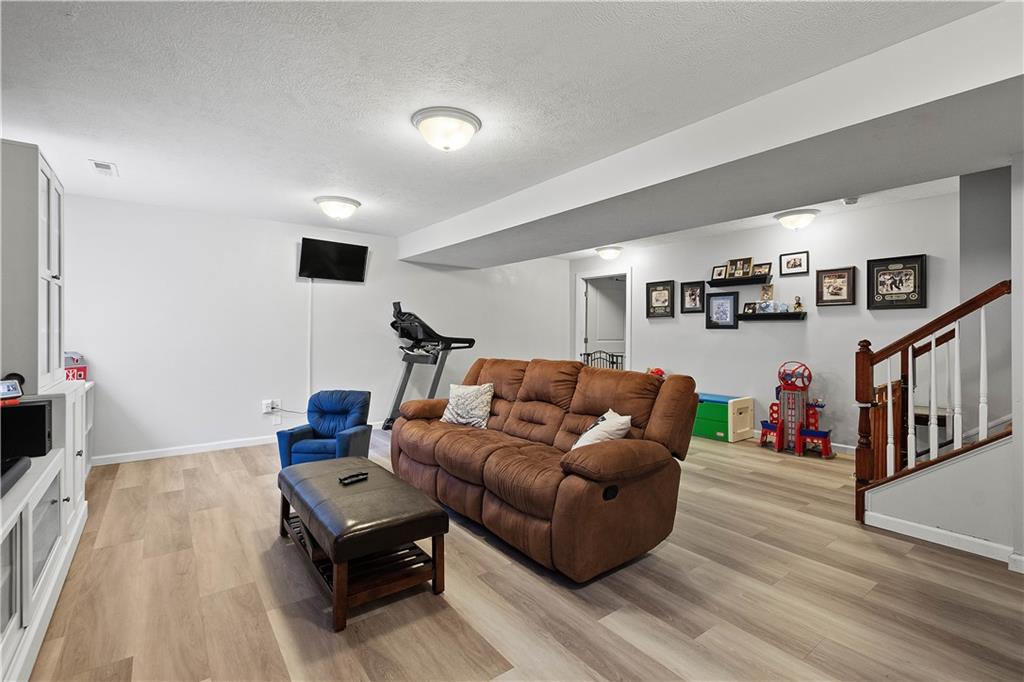 5018 Firwood Drive Canonsburg, PA 15317 - Photo 34 of 50 a living room with furniture and a flat screen tv