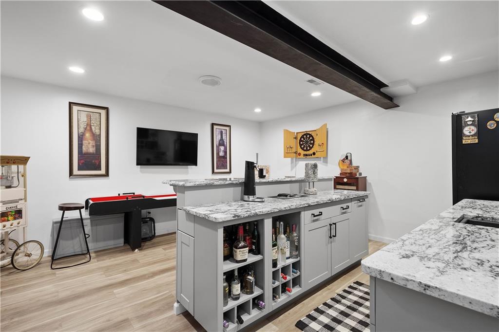 5018 Firwood Drive Canonsburg, PA 15317 - Photo 36 of 50 a view of kitchen island a sink wooden floor and a flat screen tv