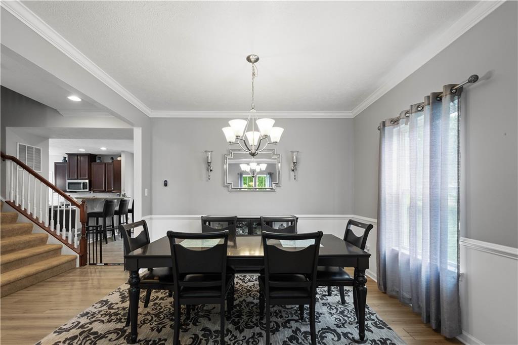 5018 Firwood Drive Canonsburg, PA 15317 - Photo 8 of 50 a view of a dining room with furniture a chandelier and wooden floor
