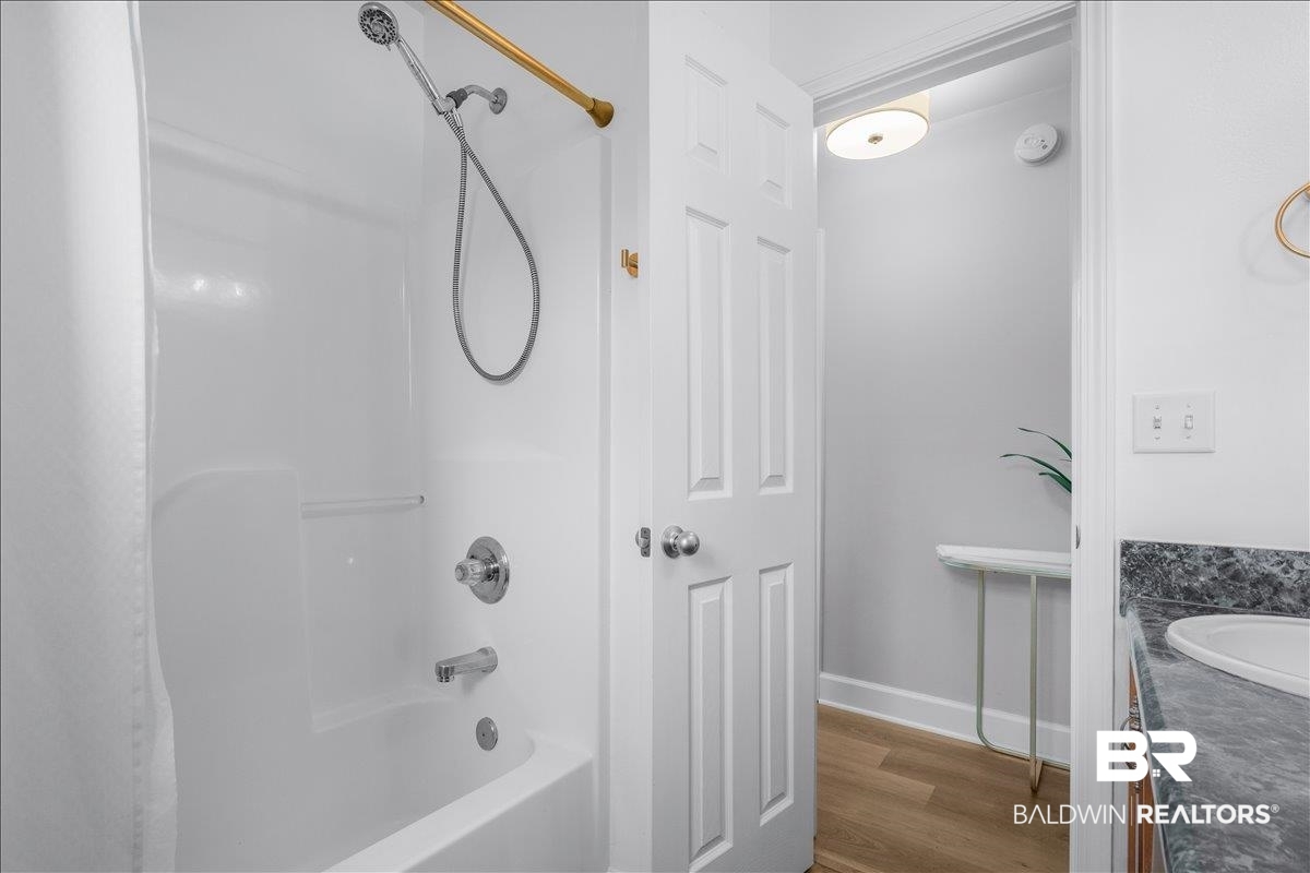 8952 Sherman Road Foley, AL 36535 - Photo 22 of 41 Bathroom featuring a white shower/tub combination with a handheld showerhead and a gold-finish shower rod