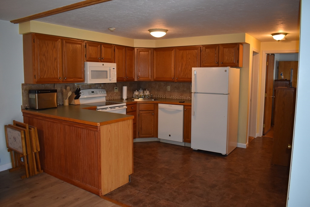 a kitchen with sink a refrigerator and cabinets