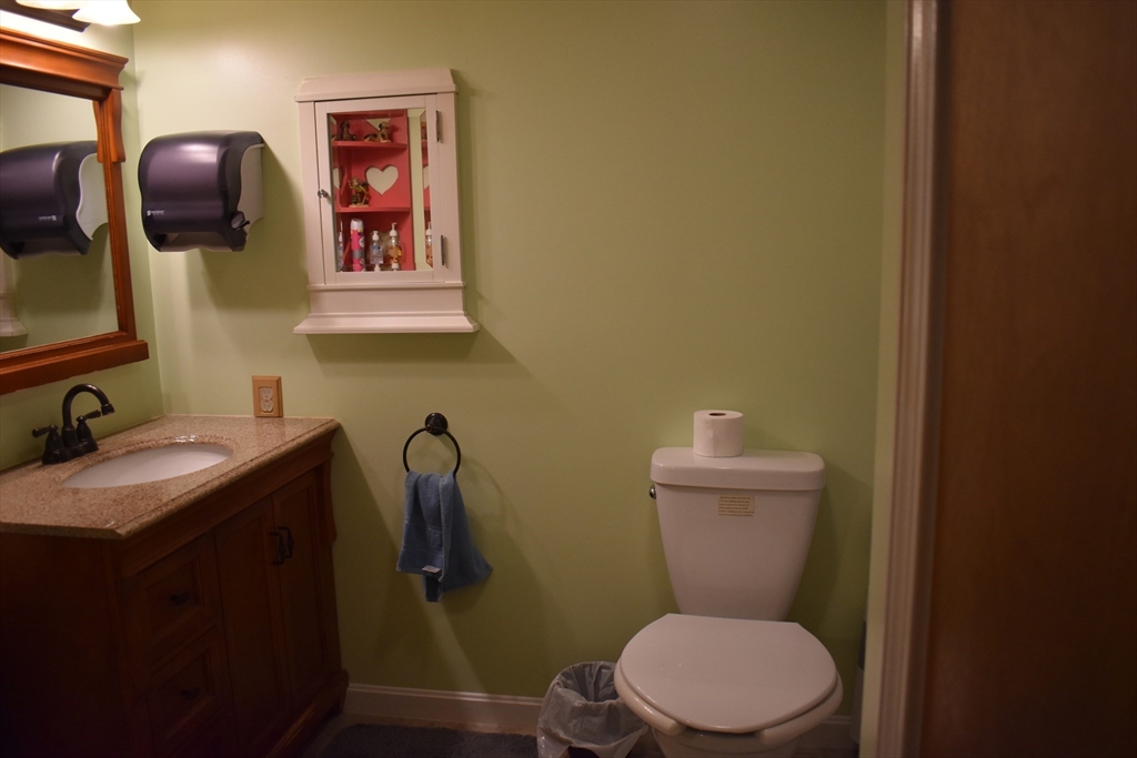 11 Hulbert Road, Unit 1 Worcester, MA 01603 - Photo 5 of 7 a bathroom with a toilet a sink and mirror