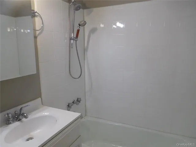 a bathroom with a granite countertop shower and a sink