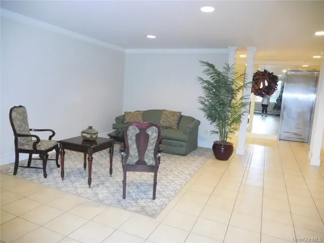 a view of a livingroom with furniture and a potted plant