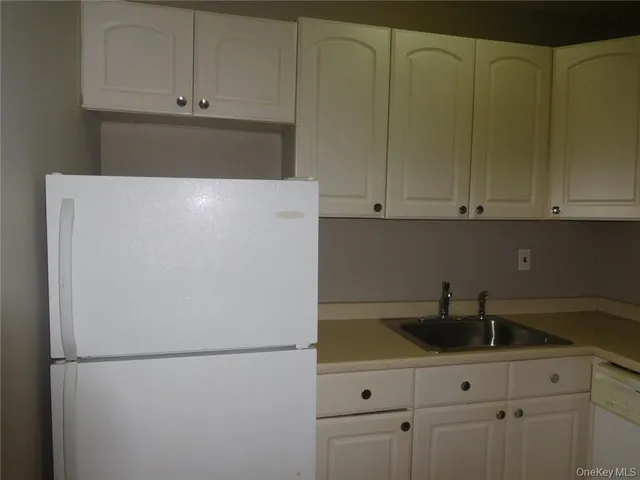 a white refrigerator freezer sitting inside of a kitchen