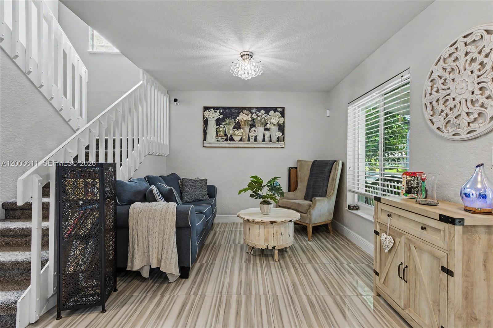 7941 Northwest 3rd Place Plantation, FL 33324 - Photo 19 of 51 a living room with furniture a wooden floor and a chandelier