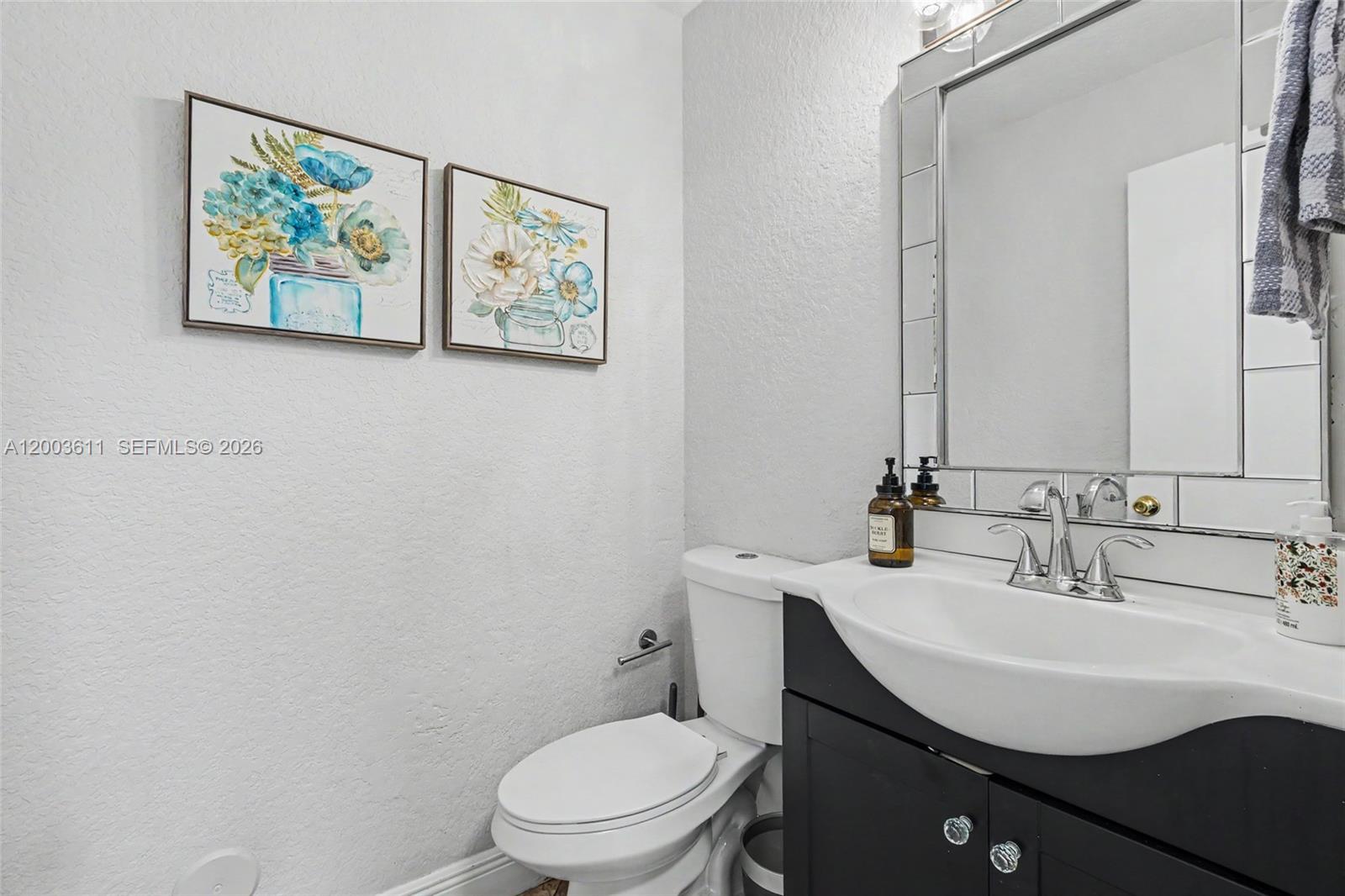 7941 Northwest 3rd Place Plantation, FL 33324 - Photo 23 of 51 a bathroom with a toilet a sink and mirror