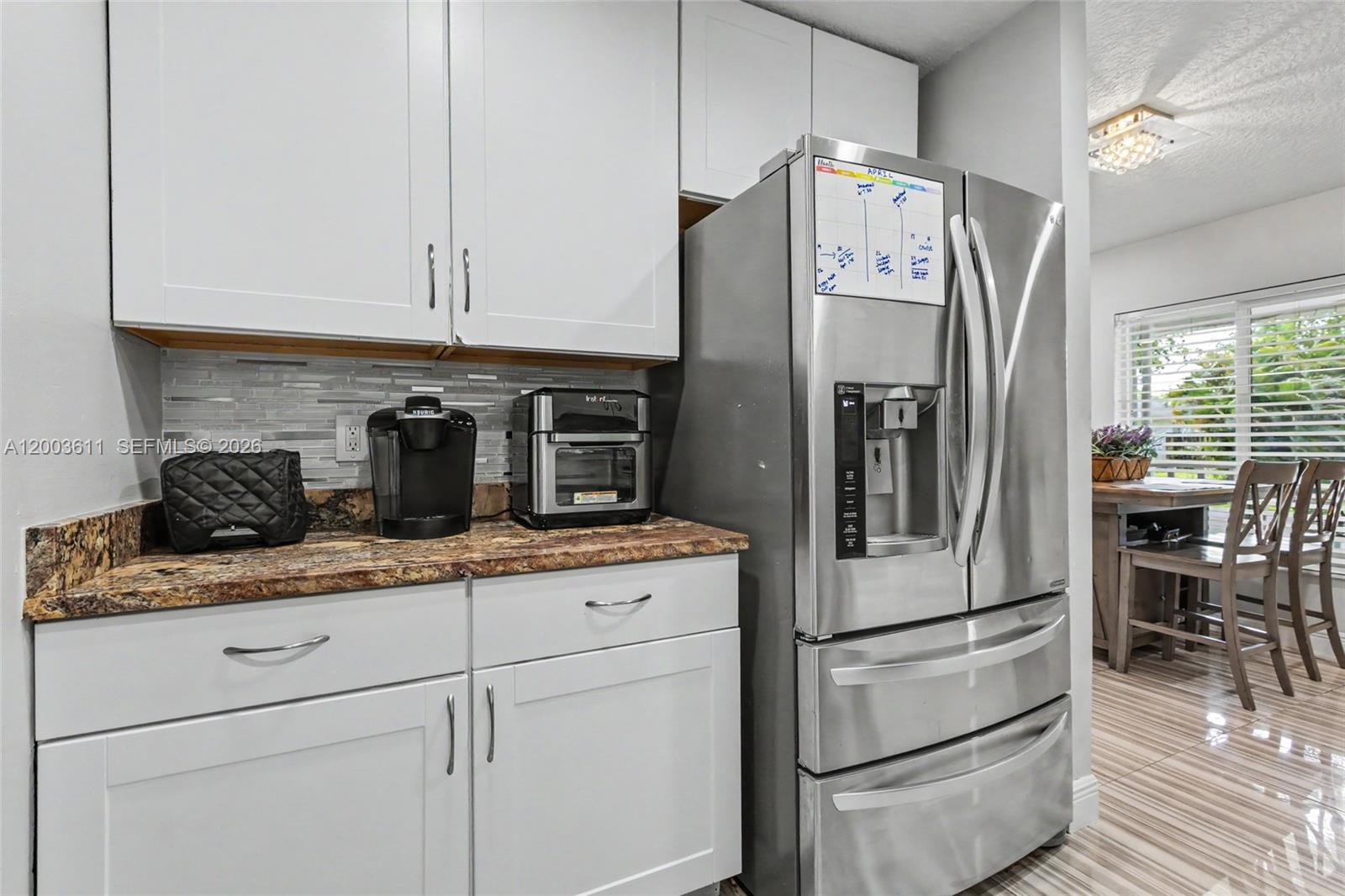 7941 Northwest 3rd Place Plantation, FL 33324 - Photo 24 of 51 a kitchen with appliances a refrigerator and cabinets