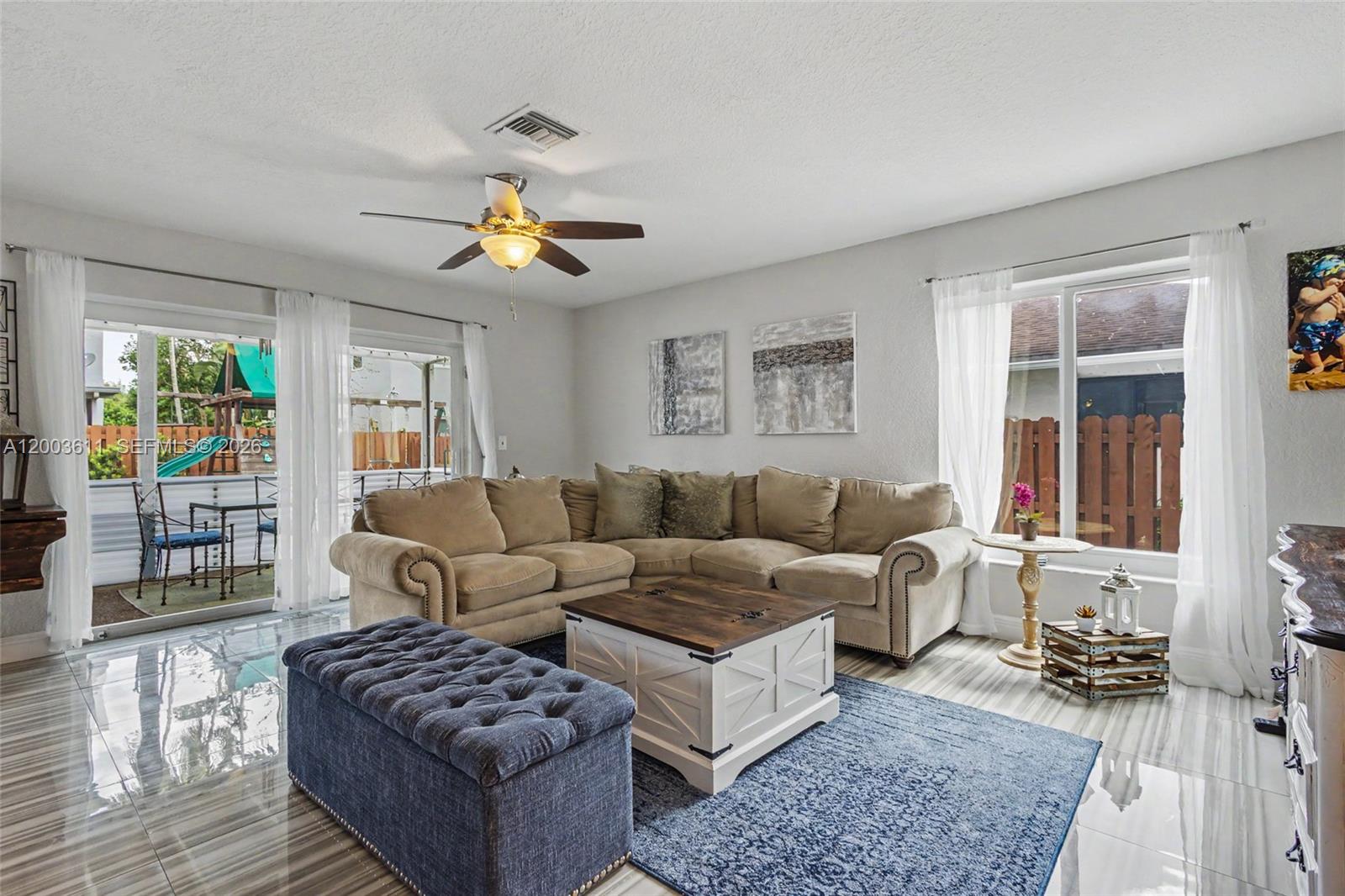 7941 Northwest 3rd Place Plantation, FL 33324 - Photo 29 of 51 a living room with furniture a rug and a chandelier