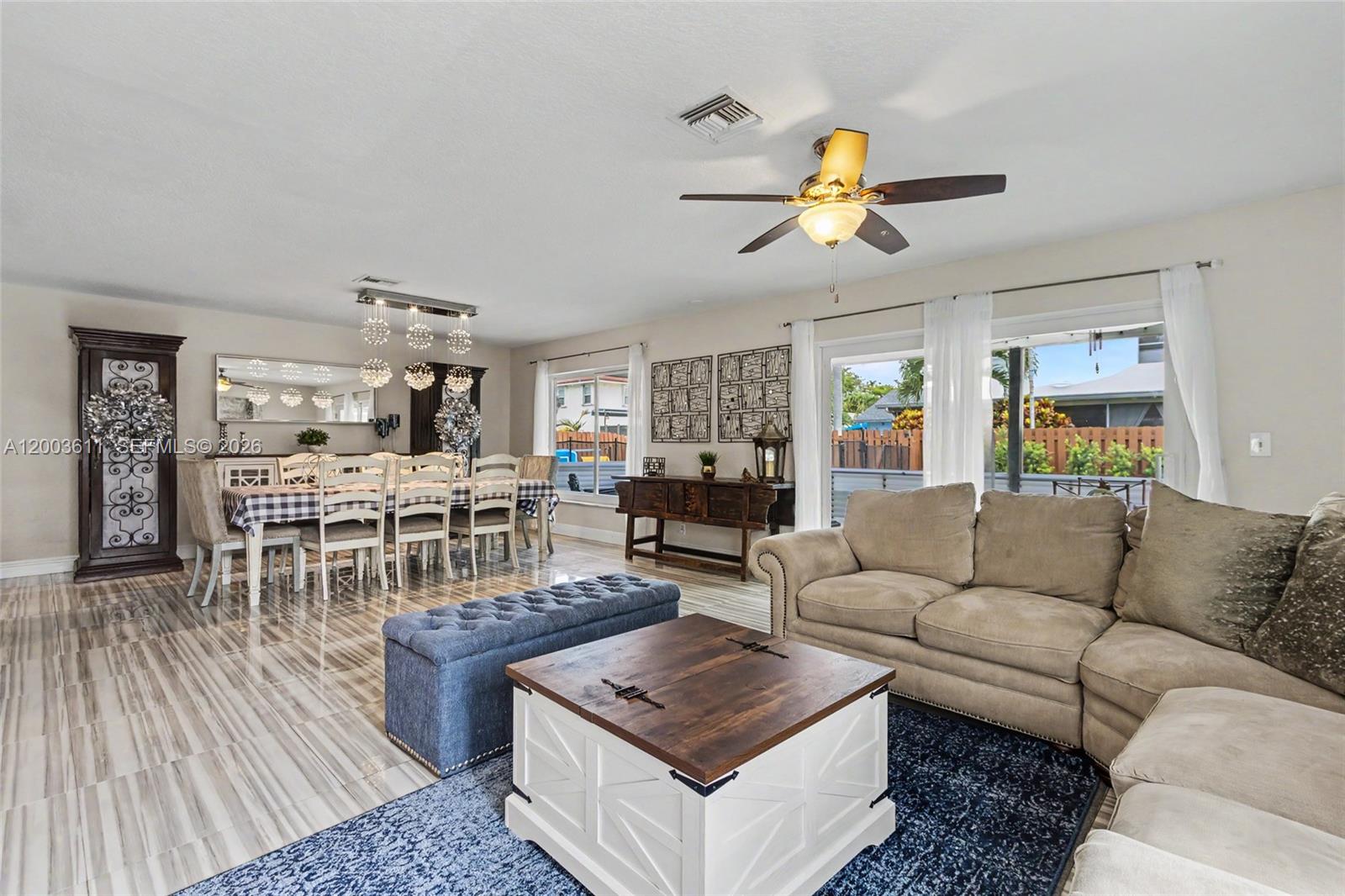 7941 Northwest 3rd Place Plantation, FL 33324 - Photo 30 of 51 a living room with furniture a dining table and a chandelier