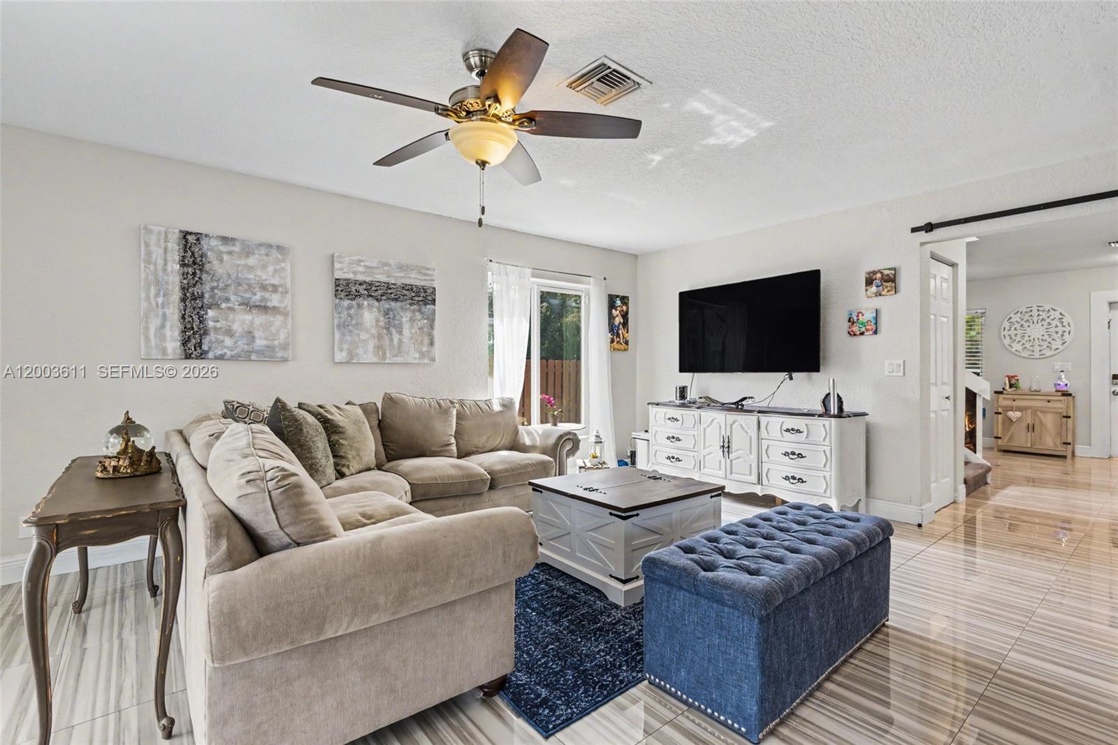 7941 Northwest 3rd Place Plantation, FL 33324 - Photo 32 of 51 a living room with furniture and a flat screen tv
