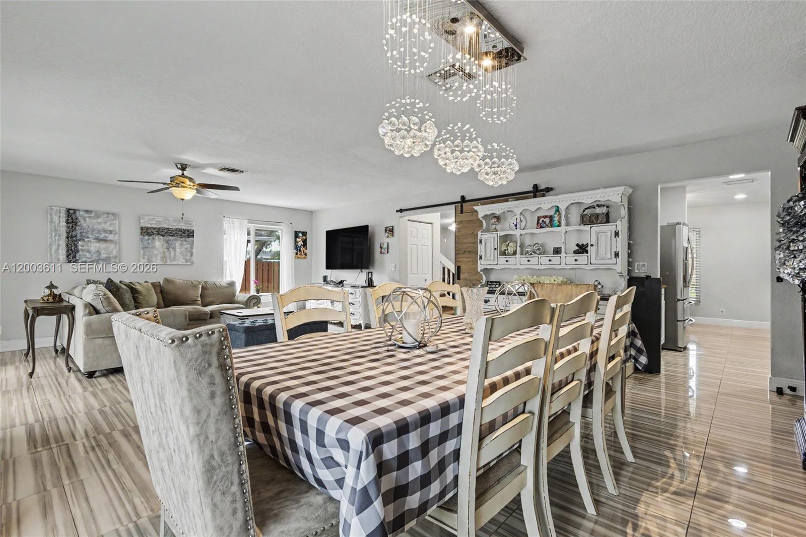 7941 Northwest 3rd Place Plantation, FL 33324 - Photo 34 of 51 a view of a dining room with furniture a chandelier and wooden floor