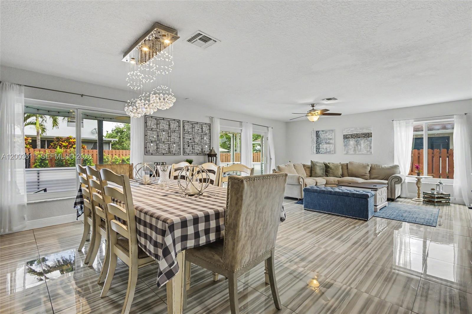 7941 Northwest 3rd Place Plantation, FL 33324 - Photo 35 of 51 a living room with furniture and a chandelier