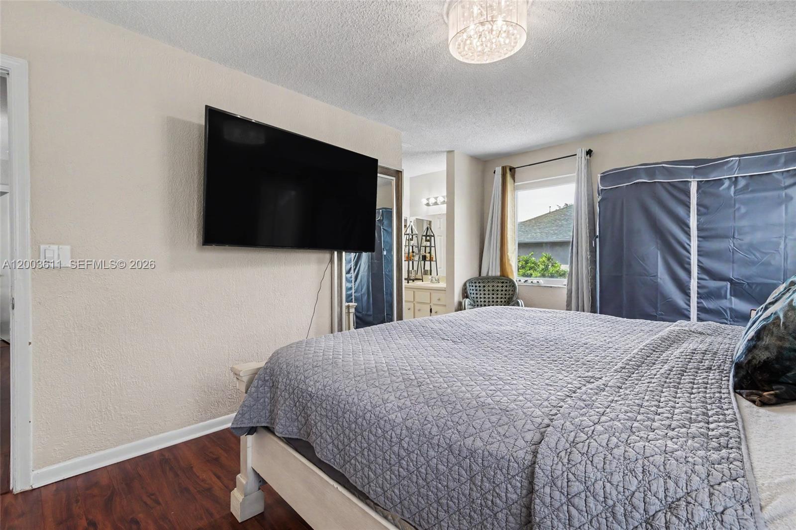 7941 Northwest 3rd Place Plantation, FL 33324 - Photo 47 of 51 a bedroom with a bed and a flat screen tv
