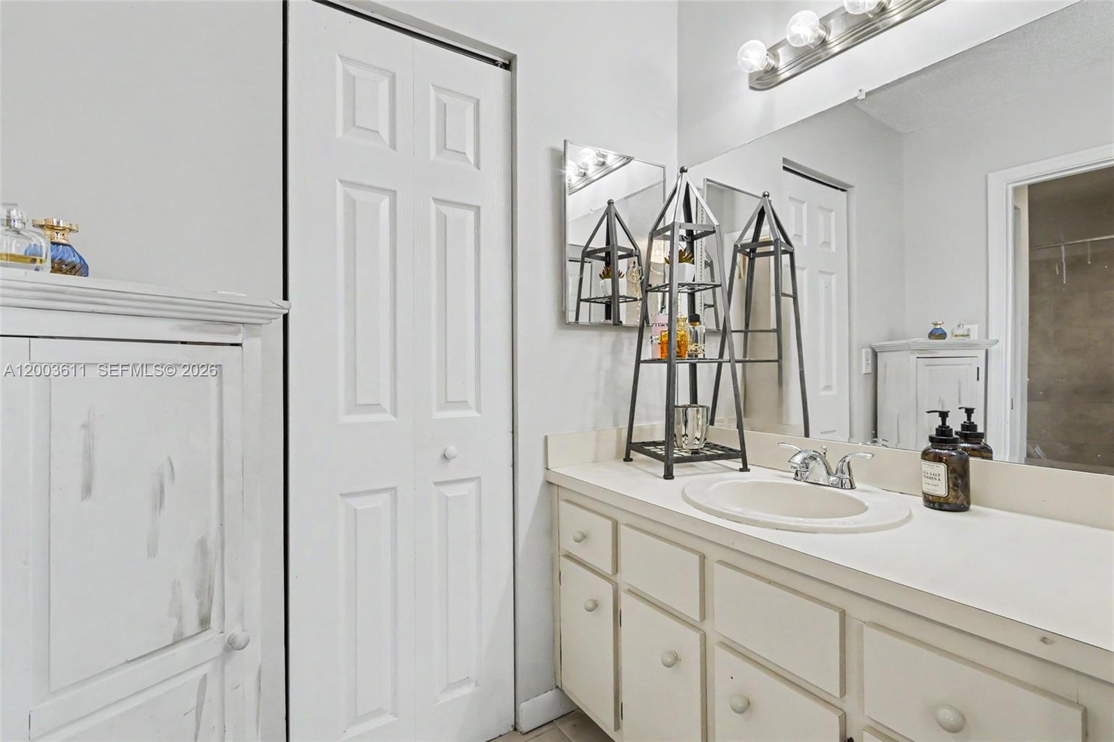 7941 Northwest 3rd Place Plantation, FL 33324 - Photo 48 of 51 a bathroom with a sink and a mirror