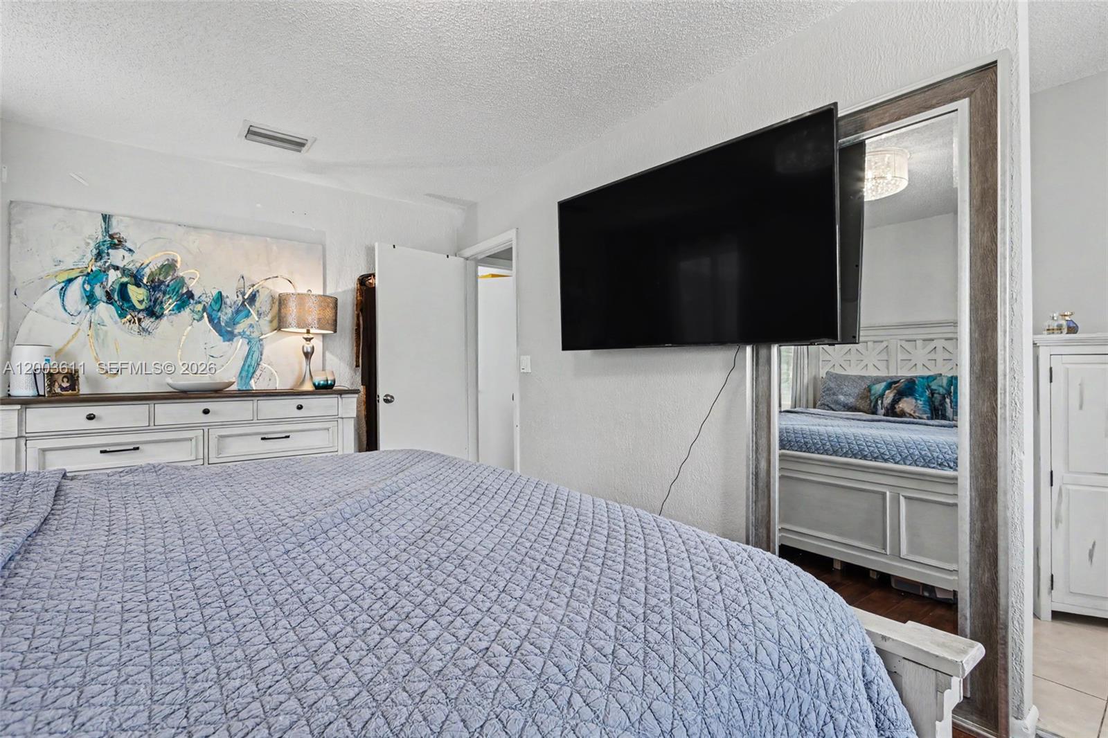 7941 Northwest 3rd Place Plantation, FL 33324 - Photo 51 of 51 a bedroom with a bed and a flat screen tv