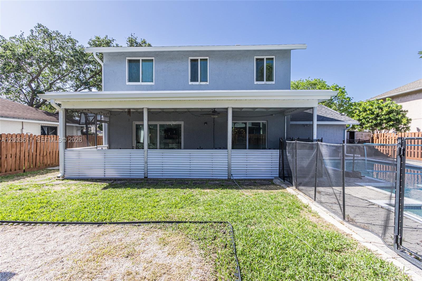 7941 Northwest 3rd Place Plantation, FL 33324 - Photo 8 of 51 a front view of a house with a yard and outdoor seating