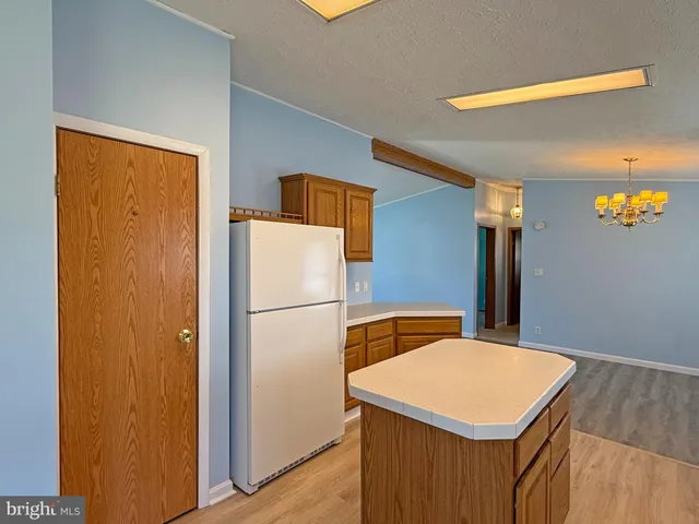 a white refrigerator freezer sitting inside of a kitchen