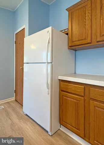 a white refrigerator freezer sitting in a kitchen