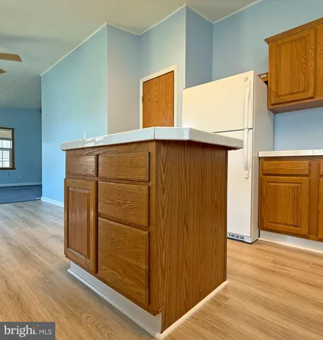 a view of walk in closet with wooden floor