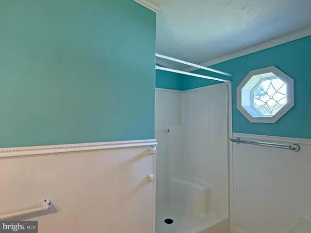 a bathroom with a light fixture and a shower