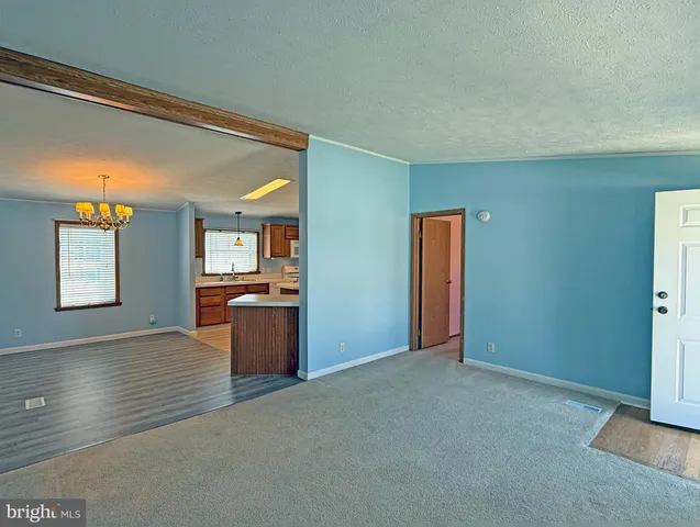 a view of a livingroom with wooden floor and windows