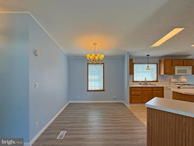 a kitchen with a refrigerator and a stove top oven