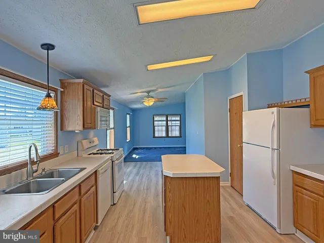 a kitchen that has a sink a refrigerator and a sink