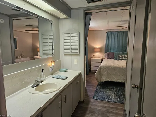 a en suite bathroom with a double vanity sink and a mirror