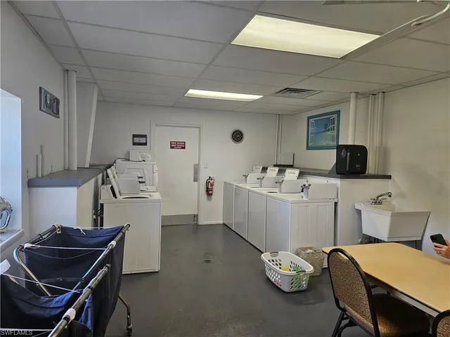 a room with a table chairs and a workspace