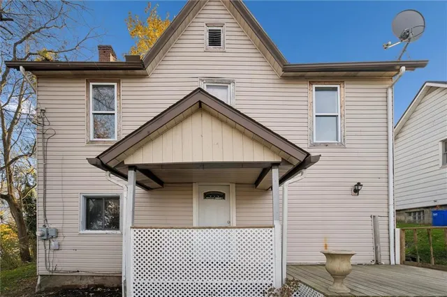 a view of a house with wooden fence