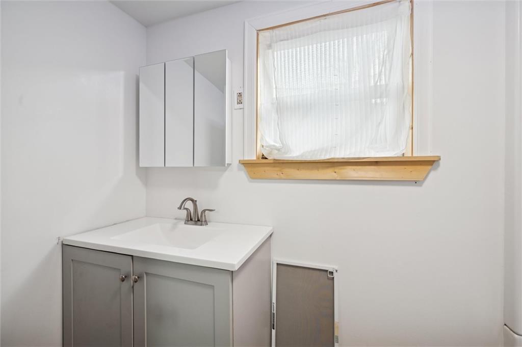 305 American Avenue Butler, PA 16001 - Photo 9 of 16 a bathroom with a sink and a mirror