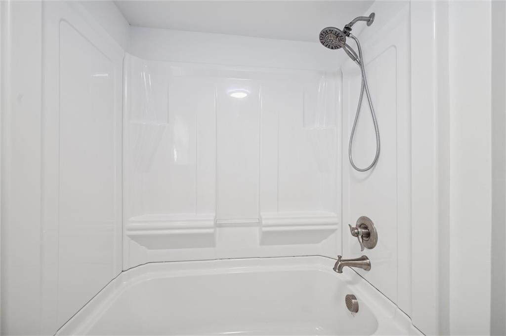 305 American Avenue Butler, PA 16001 - Photo 10 of 16 a bathroom with a bath tub with a shower