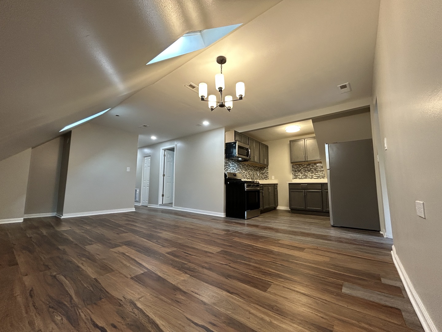 4834 North Ridgeway Avenue, Unit 3 Chicago, IL 60625 - Photo 2 of 12 a view of a kitchen with a sink and dishwasher a kitchen island with wooden floor