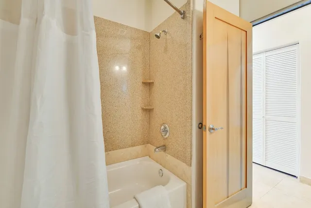 a bathroom with a tub and shower