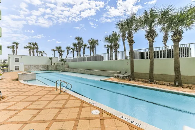 a swimming pool with outdoor seating and yard
