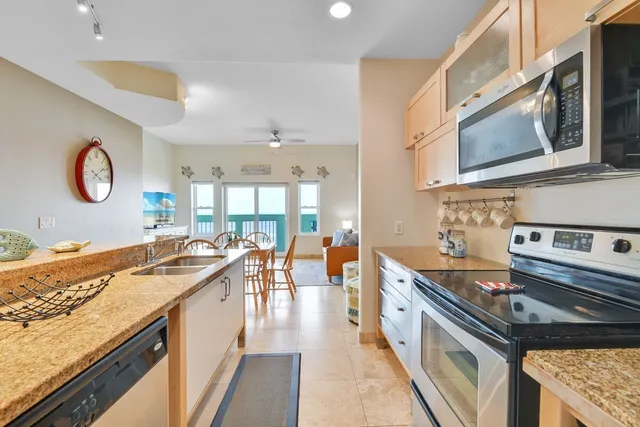 a kitchen with stainless steel appliances granite countertop a stove and a sink