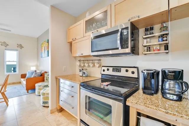 a kitchen with stainless steel appliances granite countertop a stove and a microwave