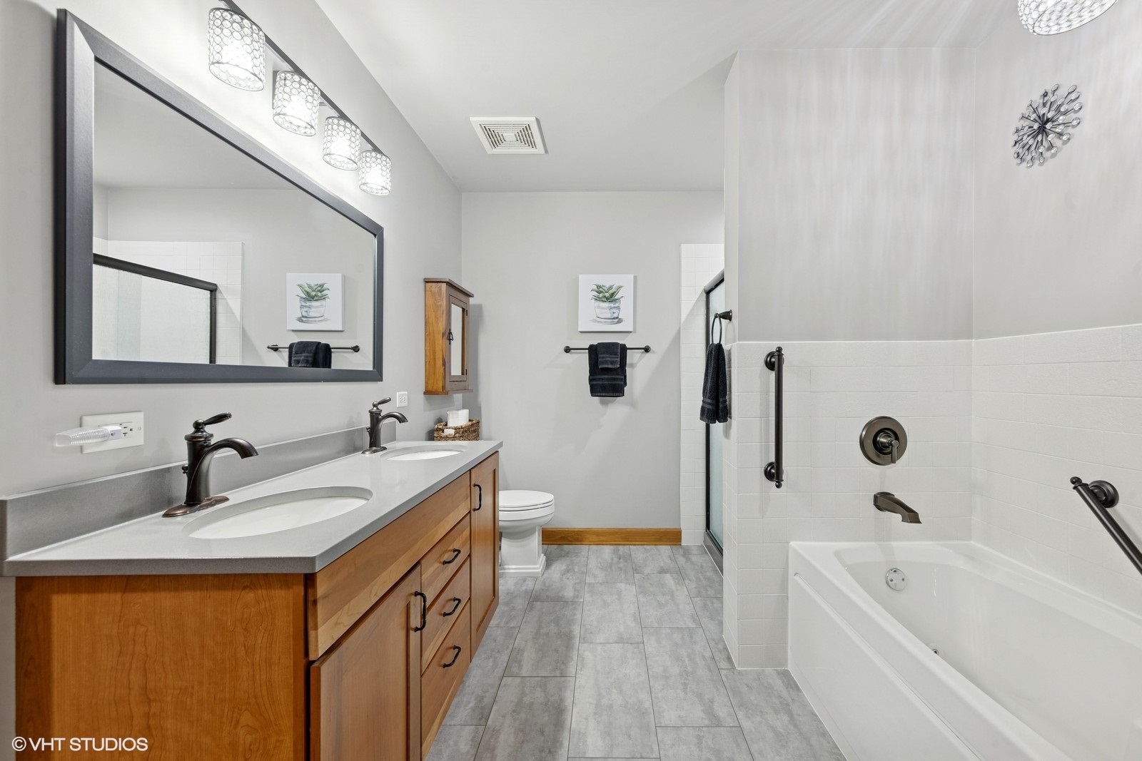 14 South Prospect Street, Unit 508 Roselle, IL 60172 - Photo 19 of 23 a bathroom with a double vanity sink a mirror a bathtub and shower