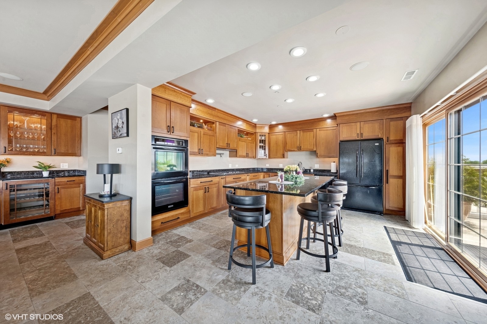 14 South Prospect Street, Unit 508 Roselle, IL 60172 - Photo 6 of 23 a kitchen with stainless steel appliances kitchen island granite countertop a refrigerator a stove a sink a dining table and chairs with wooden floor