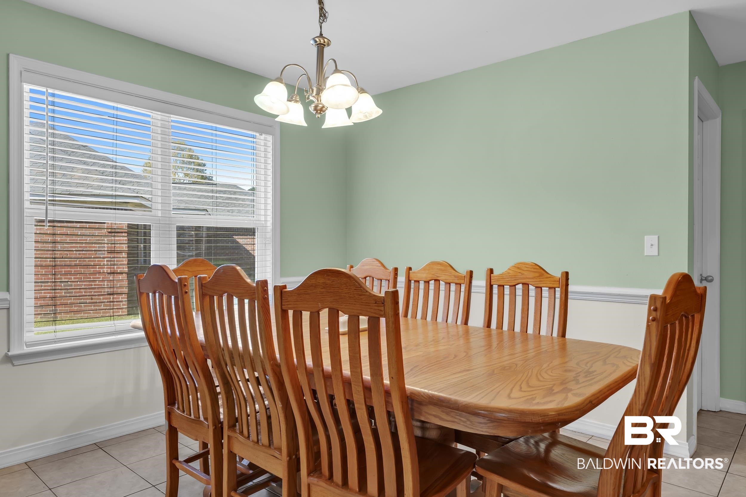 31527 Heidelbrook Loop Daphne, AL 36527 - Photo 10 of 22 Dining area with a chandelier and light tile patterned flooring